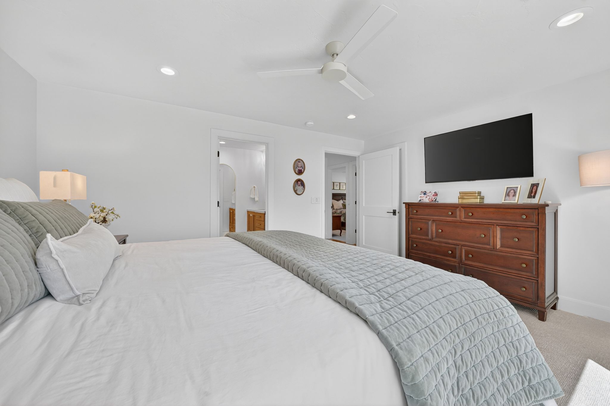 Primary bedroom featuring a ceiling fan, recessed lighting, and light-colored carpeting