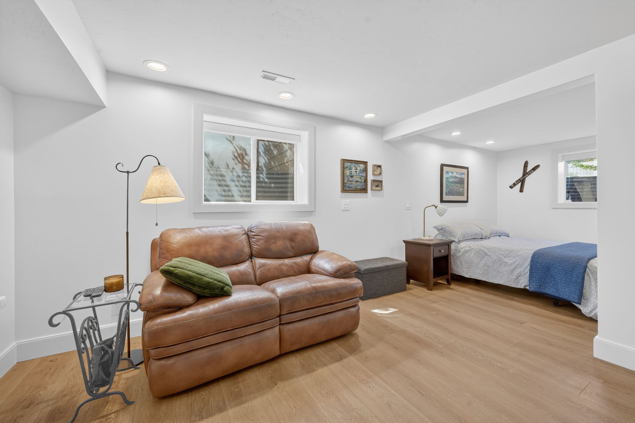 Bright room featuring recessed lighting, a window with blinds, wood-finish flooring, and white baseboards