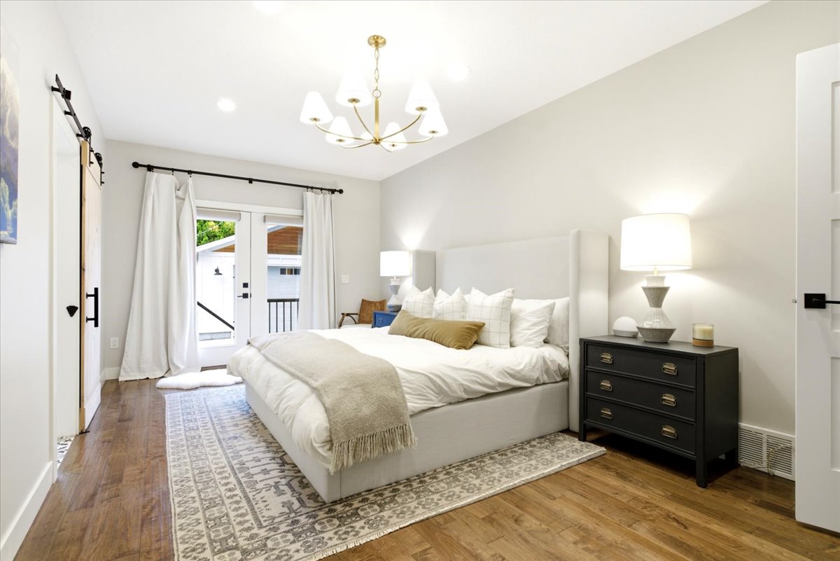 Interior room featuring wood-finish flooring, a contemporary ceiling light fixture, recessed lighting, and light-toned wall finishes