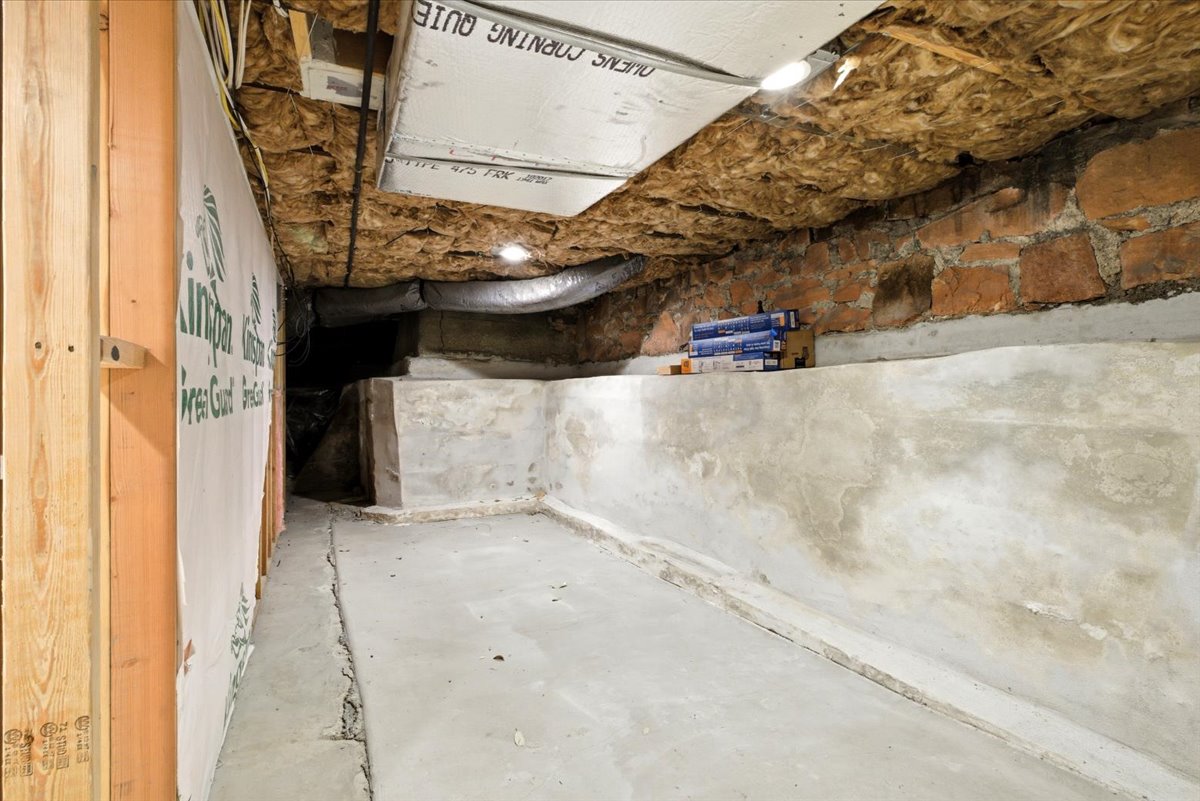 Concrete foundation with exposed brickwork and visible insulation