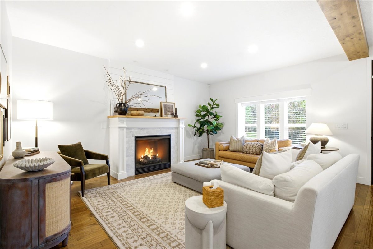 Living area featuring a classic fireplace with a stone surround and wood mantel