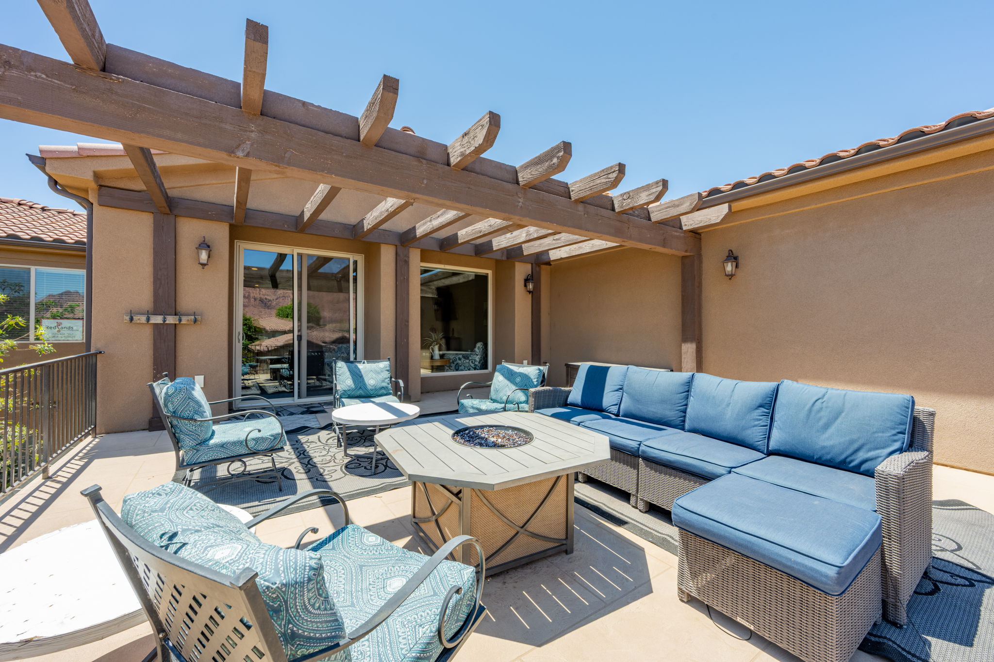 Exterior patio featuring a wood pergola and stucco finish