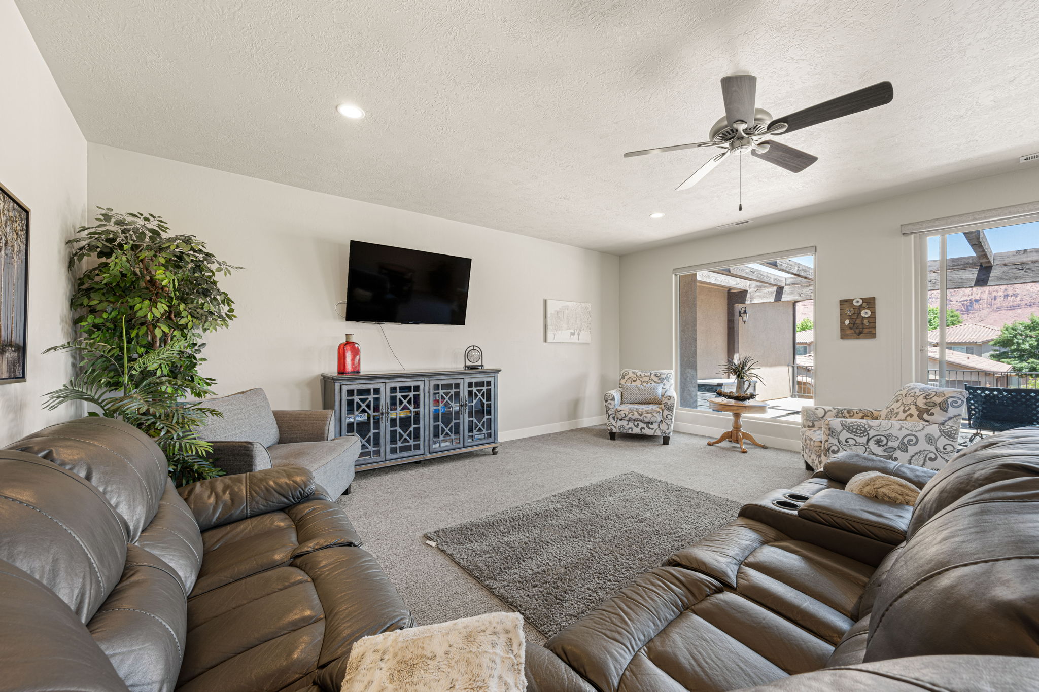 Spacious living area featuring neutral carpeting and light-toned walls