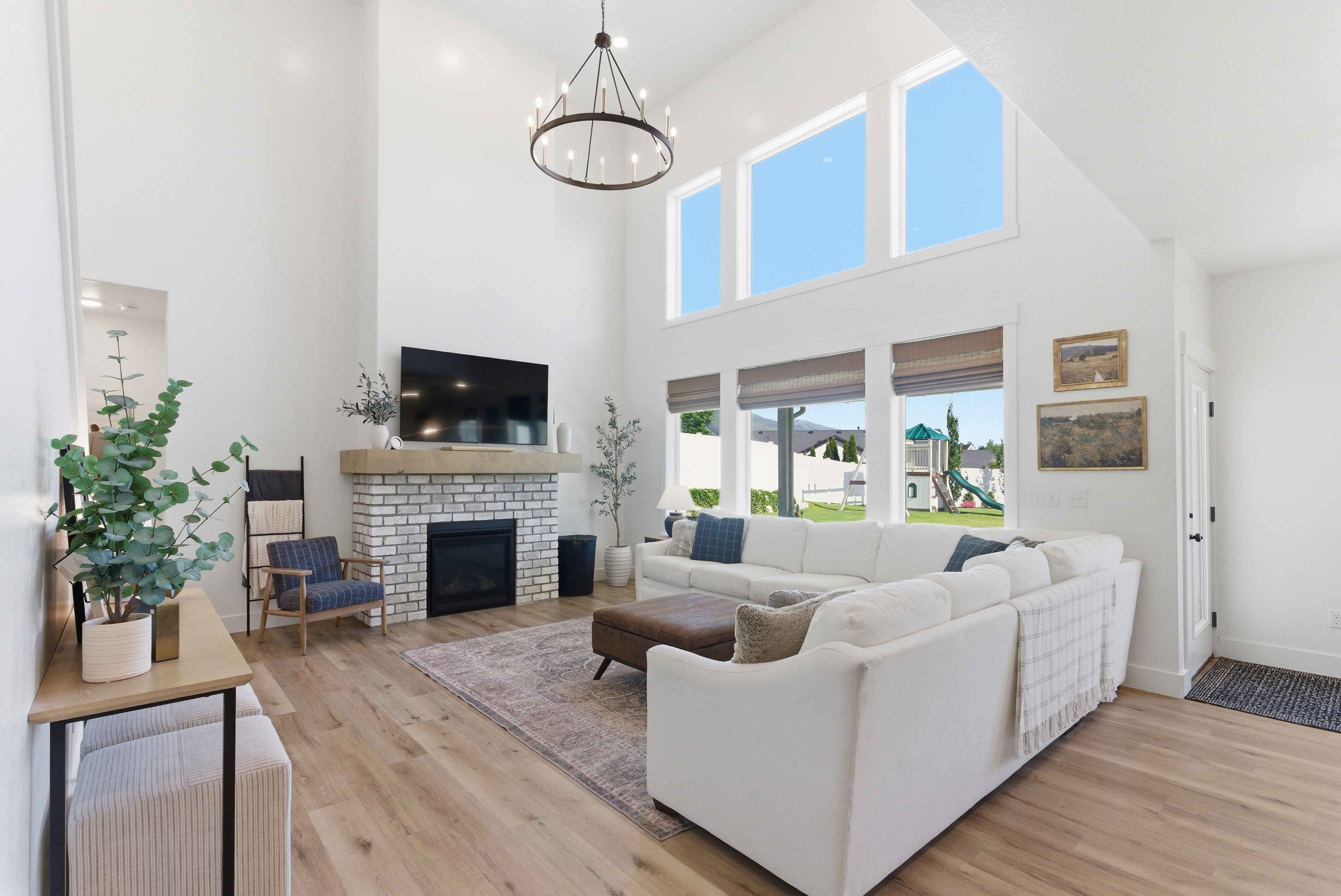 Vaulted ceiling great room with wood-finish flooring