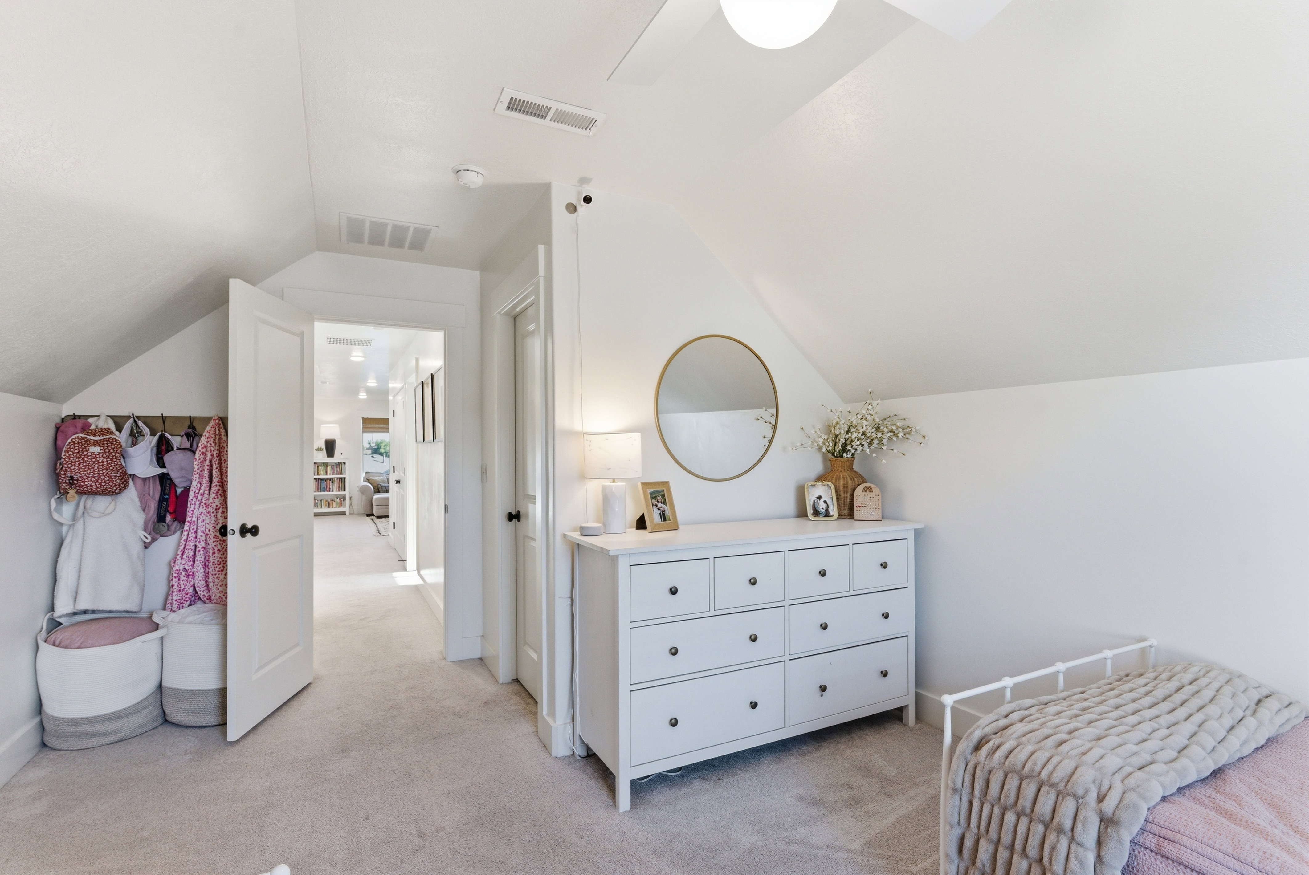 Carpeted room featuring a sloped ceiling and white walls