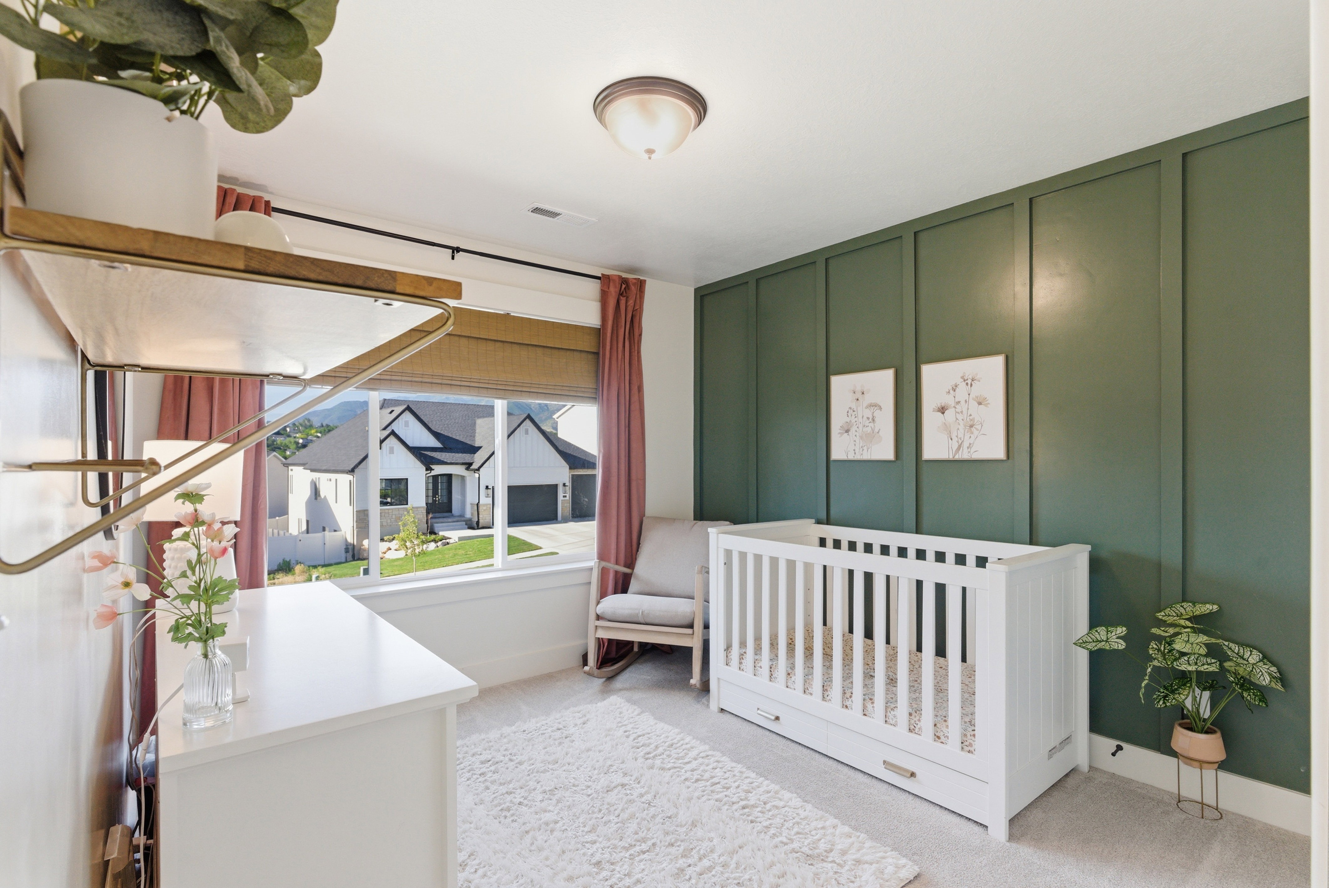 Interior space featuring a large window with roller shades, board and batten accent wall, and recessed ceiling light fixture