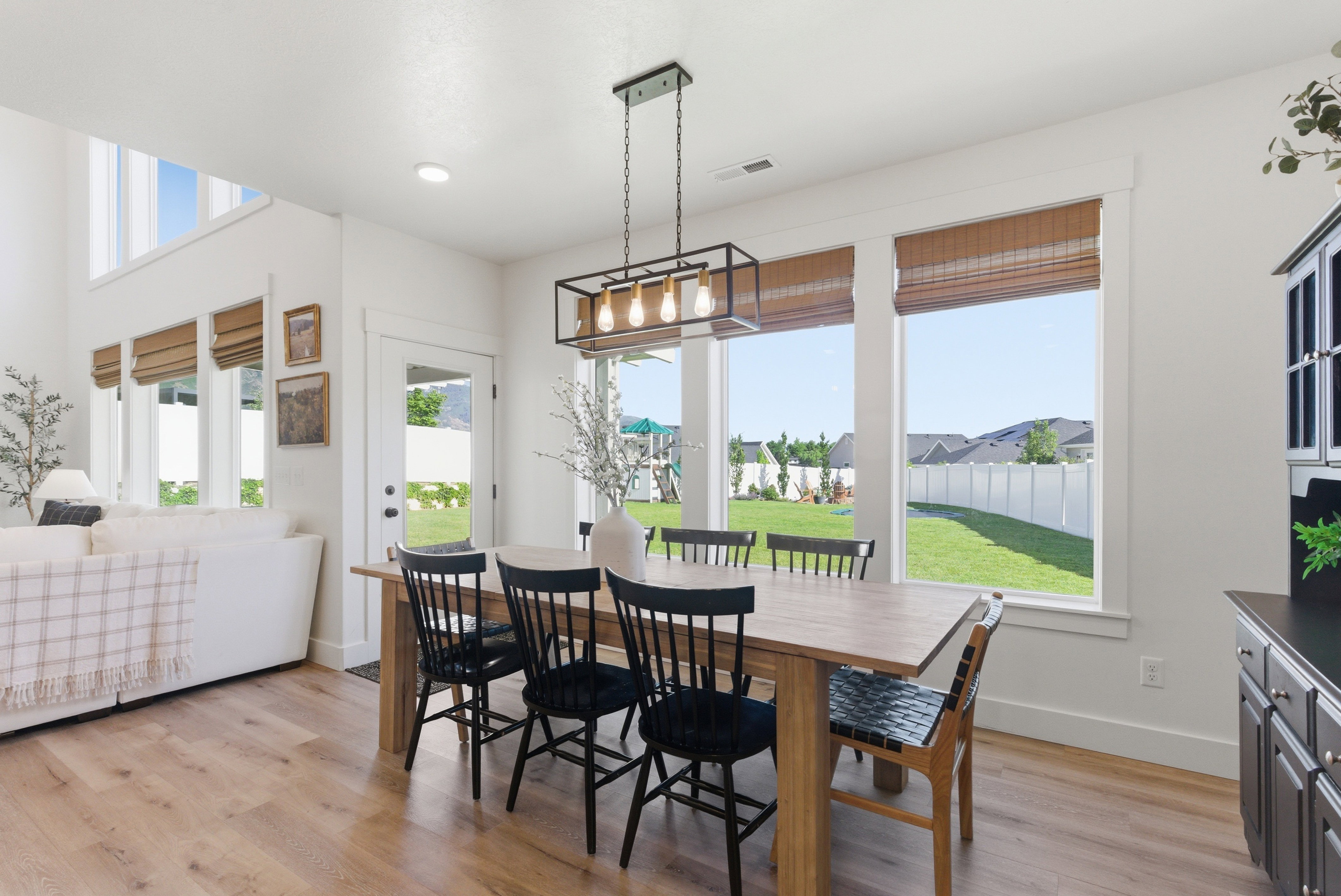 Dining area featuring wood-finish flooring and a rectangular light wood table