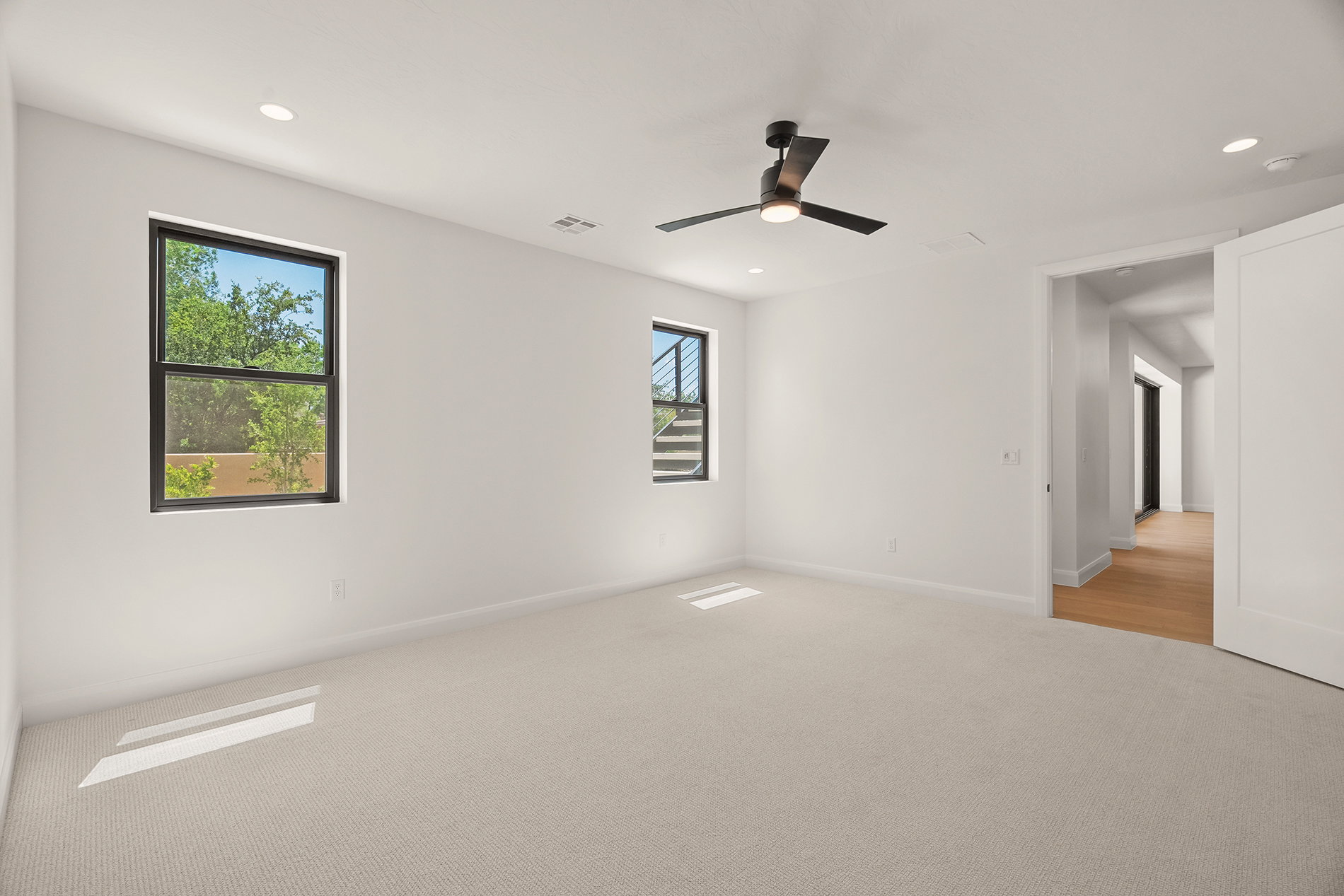 Neutral tone walls complement the light-colored carpet flooring
