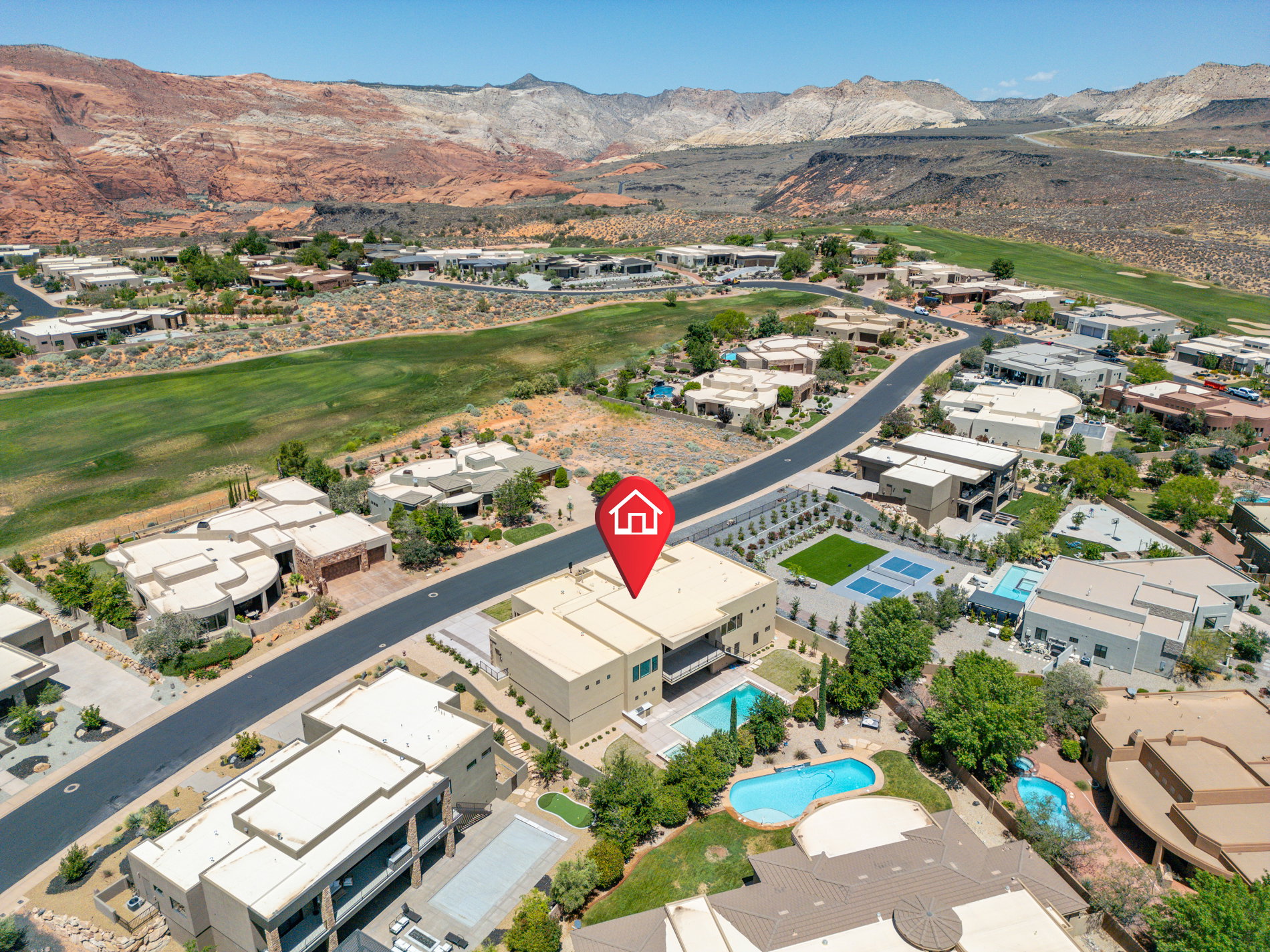 Modern desert property featuring a swimming pool, multiple private balconies, and a flat roof design