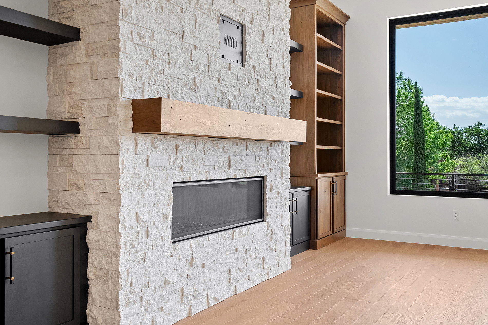 Stone-clad fireplace with a wood mantel