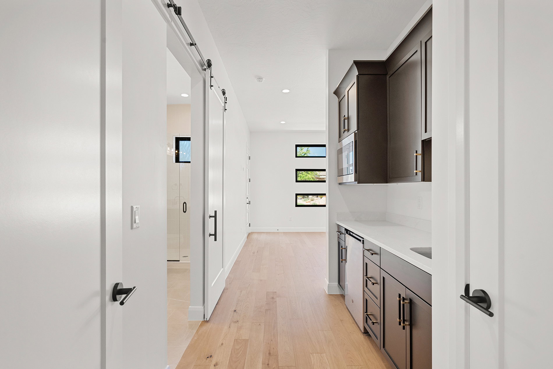 Hallway featuring light wood-finish flooring and recessed lighting