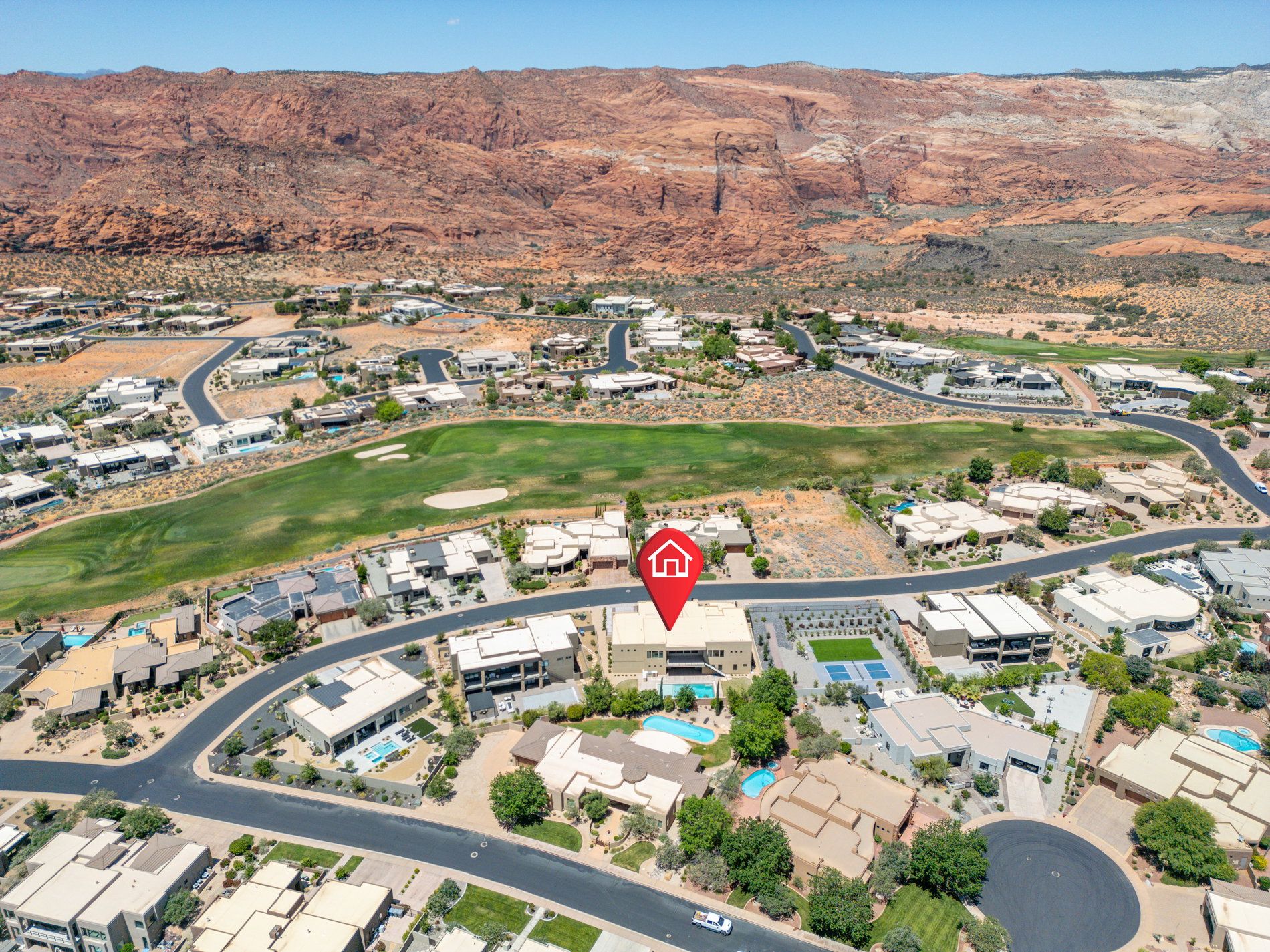 Aerial perspective showcasing a residential community with red rock mountain scenery