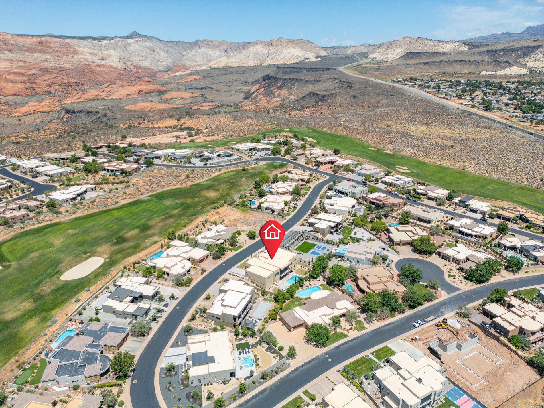 Aerial view of a residential community featuring diverse modern architecture and expansive desert landscaping