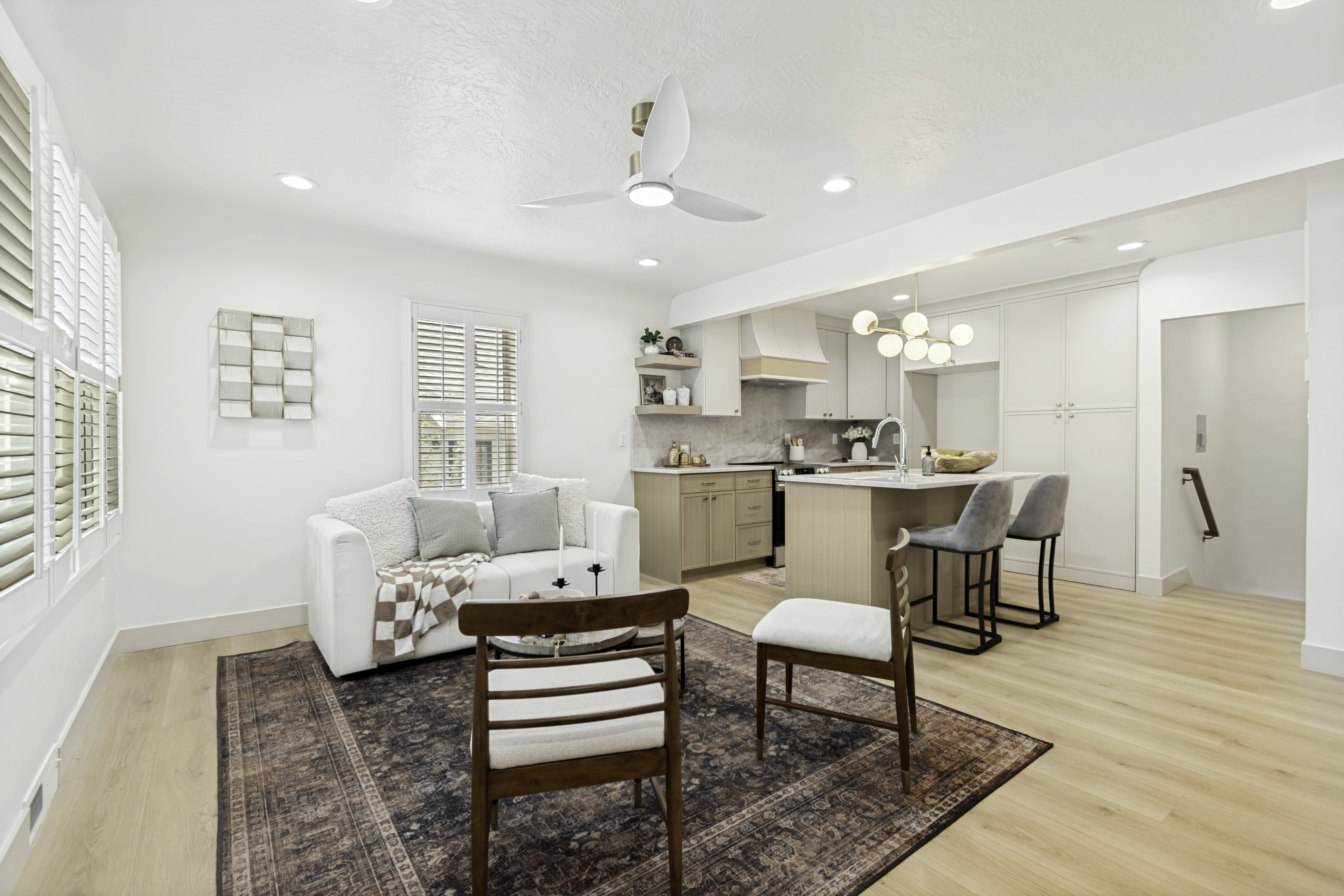 Open-concept living space featuring wood-finish flooring, recessed lighting, and a modern ceiling fan