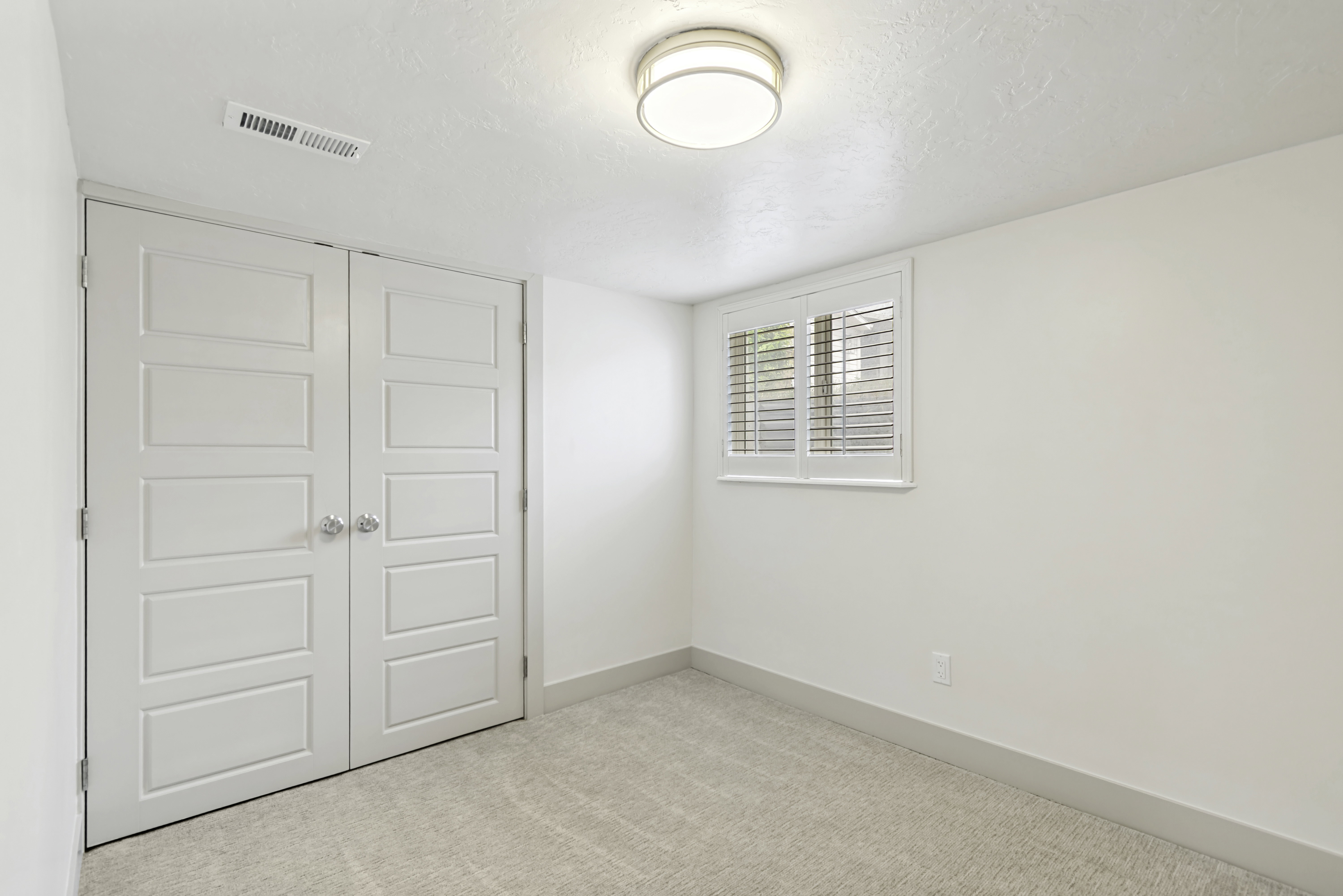 Neutral-toned carpeting paired with white walls