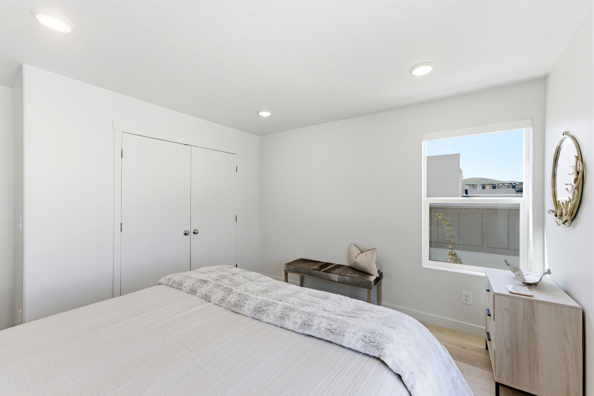 Bedroom featuring wood-finish flooring, a window with exterior views, and recessed lighting