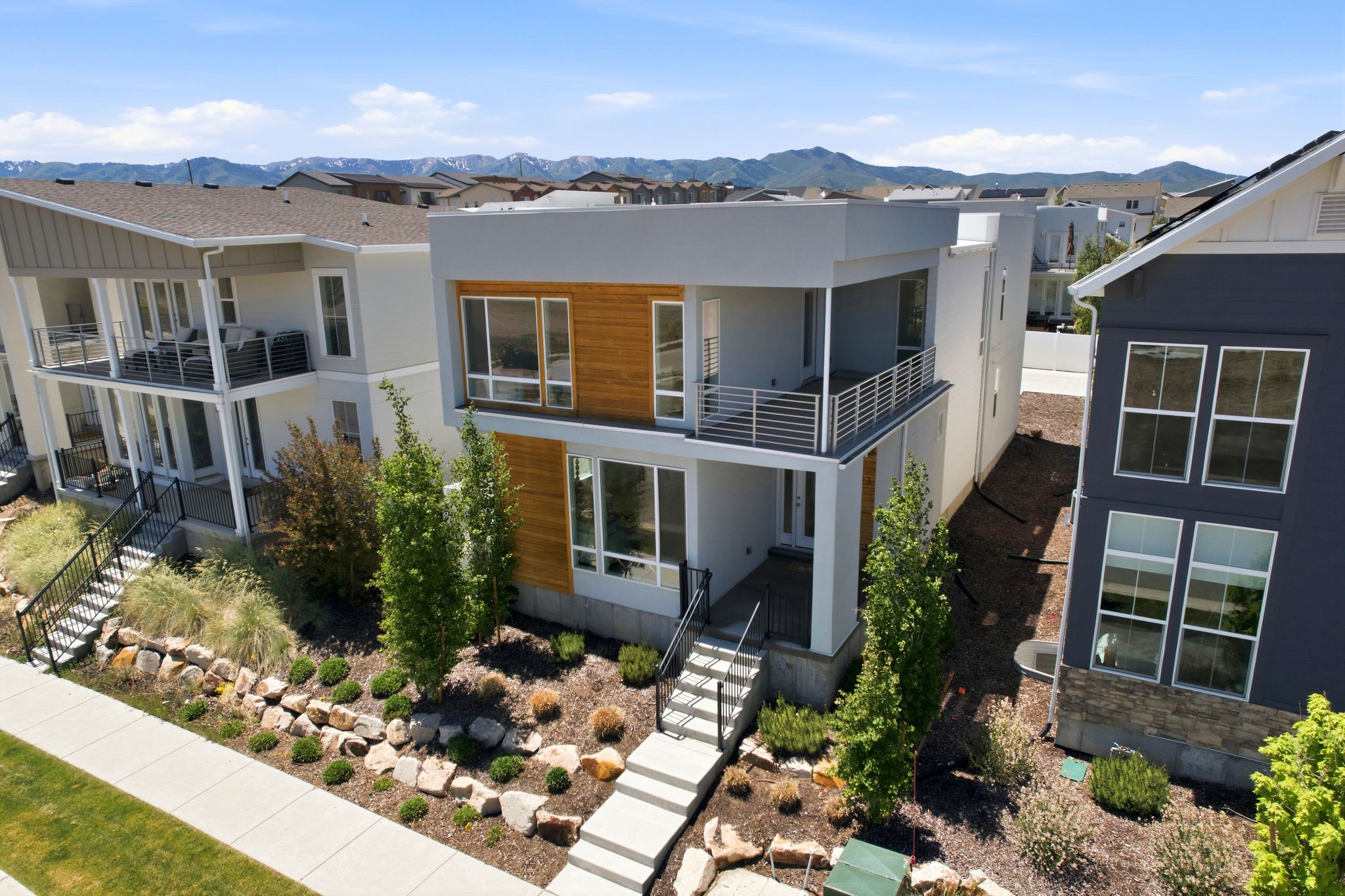 Modern architectural facade featuring light gray and wood-tone paneling