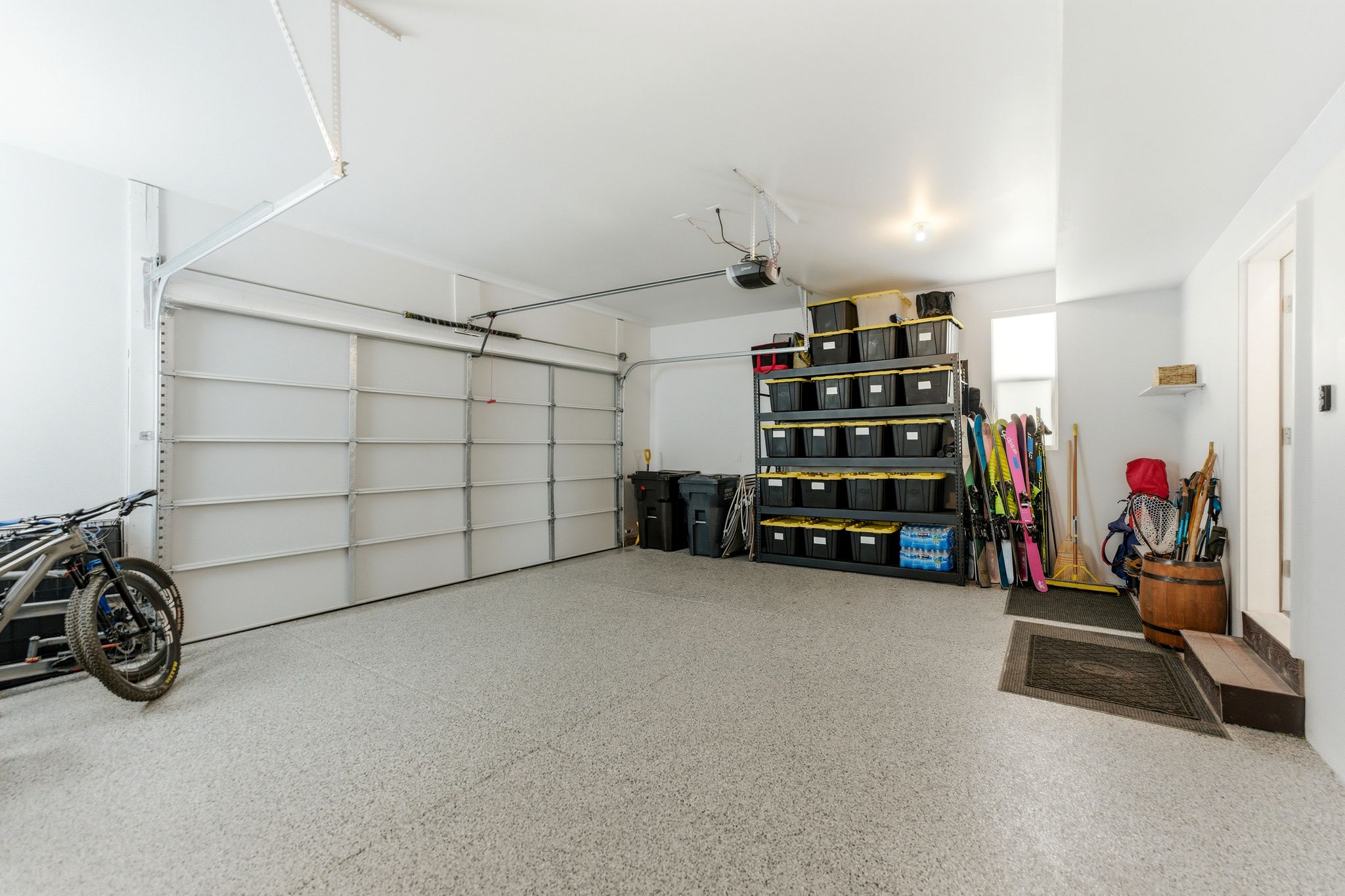 Garage with epoxy-coated flooring and a single overhead door