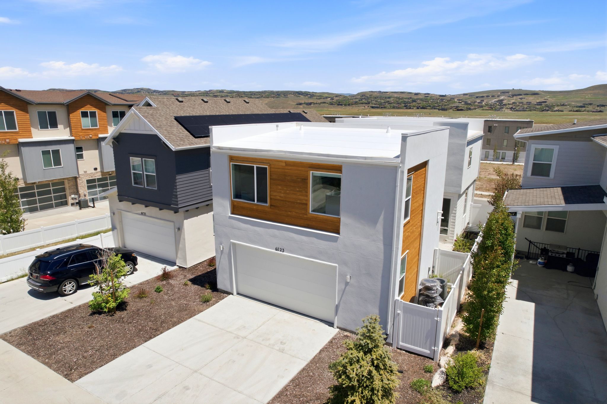 Modern exterior with white stucco and wood-finish siding accents