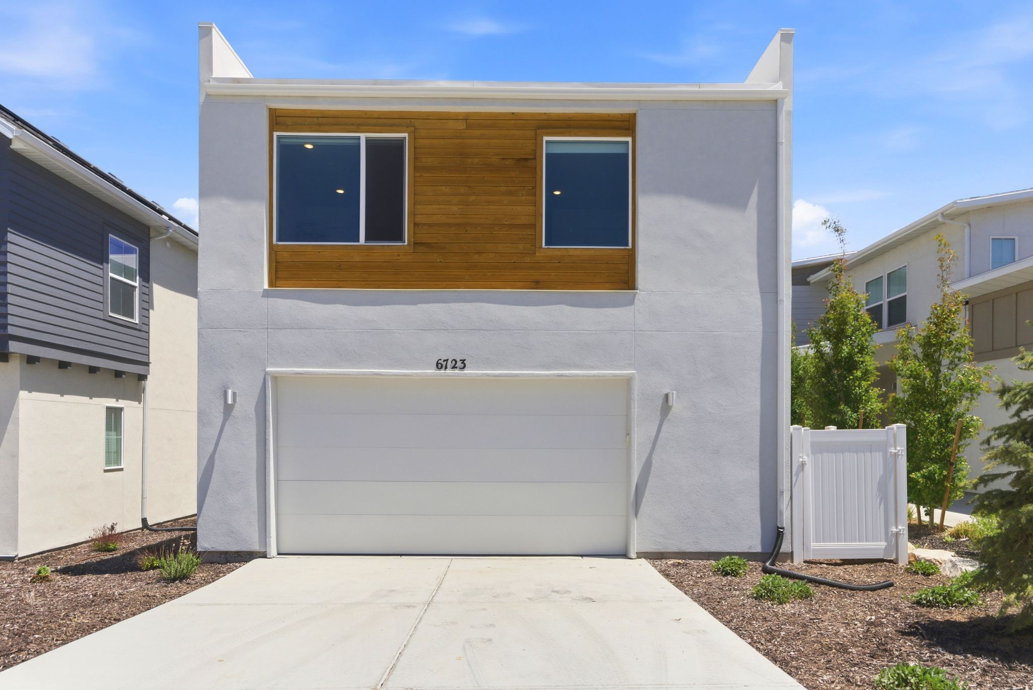 Modern stucco exterior with wood paneling accents