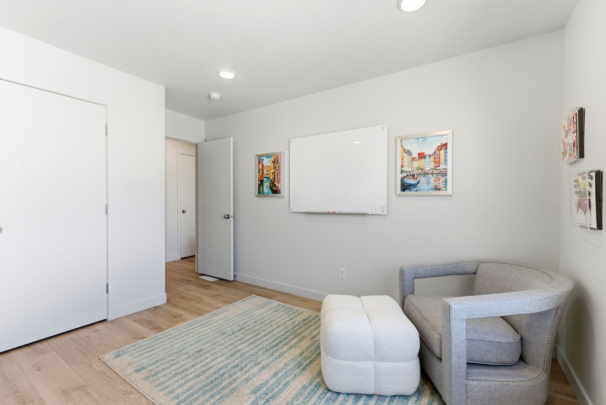 Recessed ceiling lighting, light wood-finish flooring, white baseboards, solid core doors, and painted walls