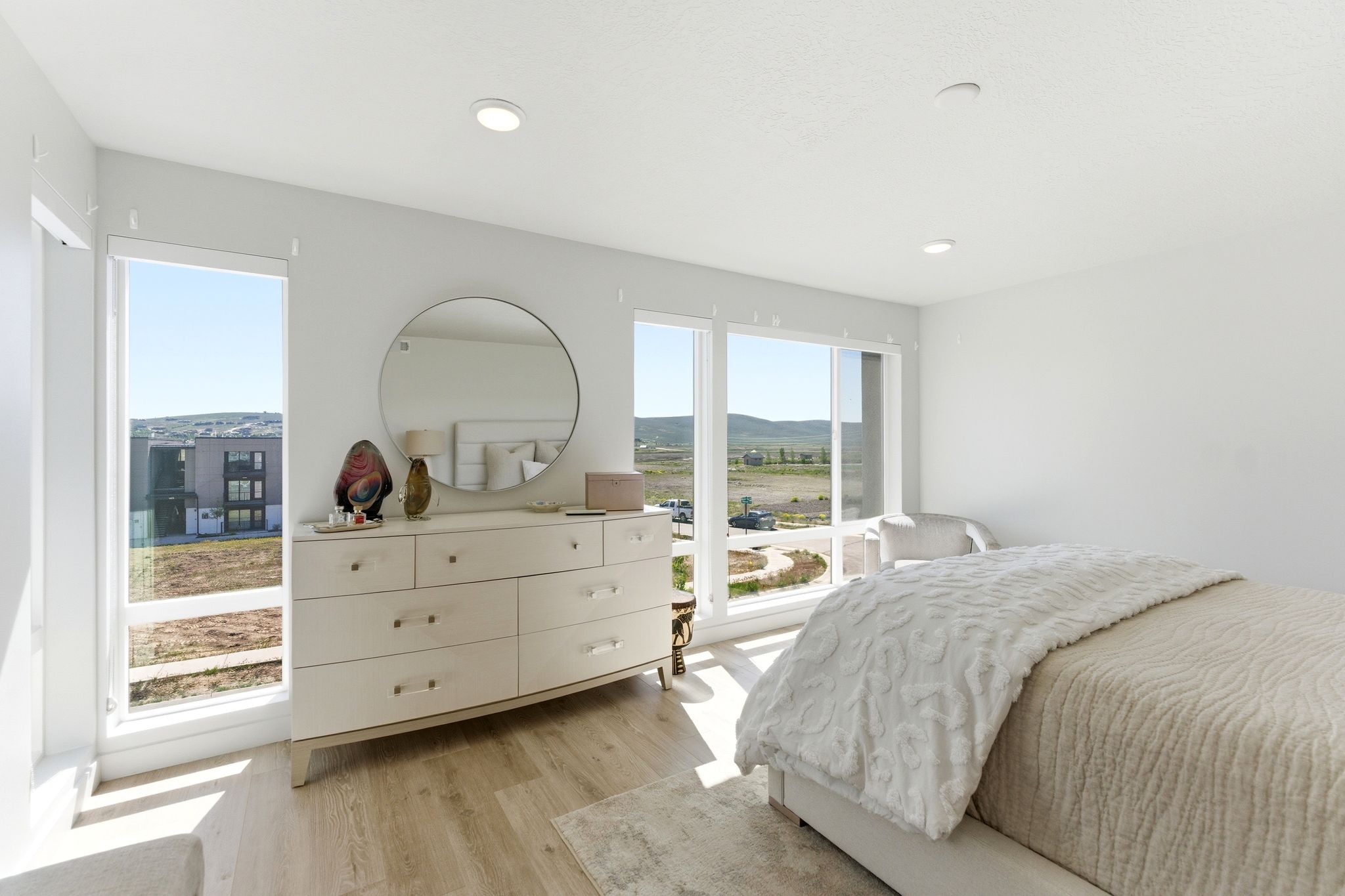 Spacious room with large windows, recessed lighting, and light wood-finish flooring