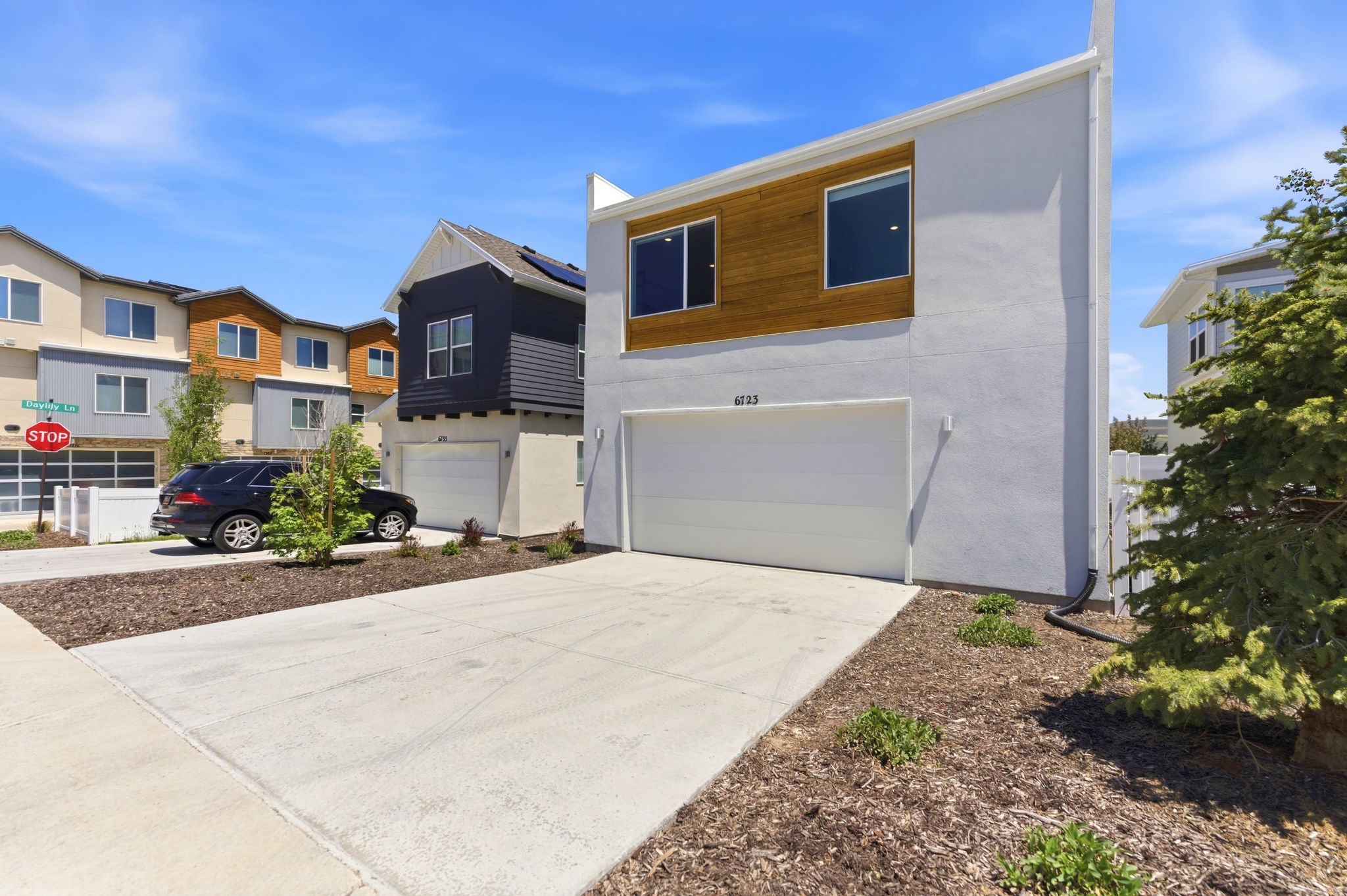 Contemporary stucco exterior with wood-finish paneling accents
