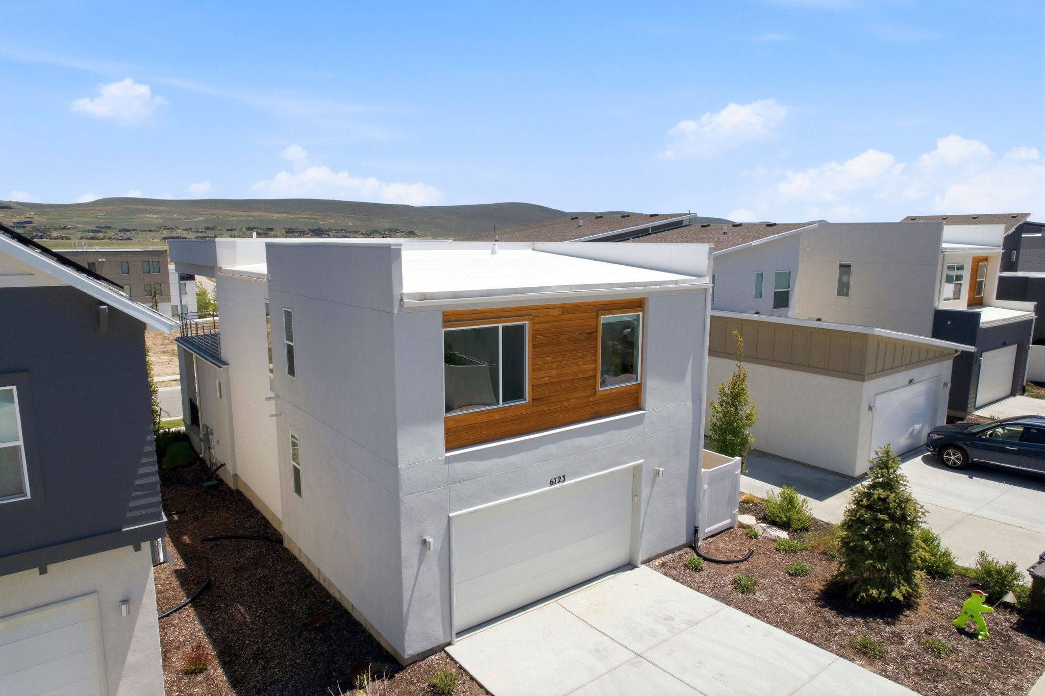 Modern architectural design featuring a flat roofline and integrated garage