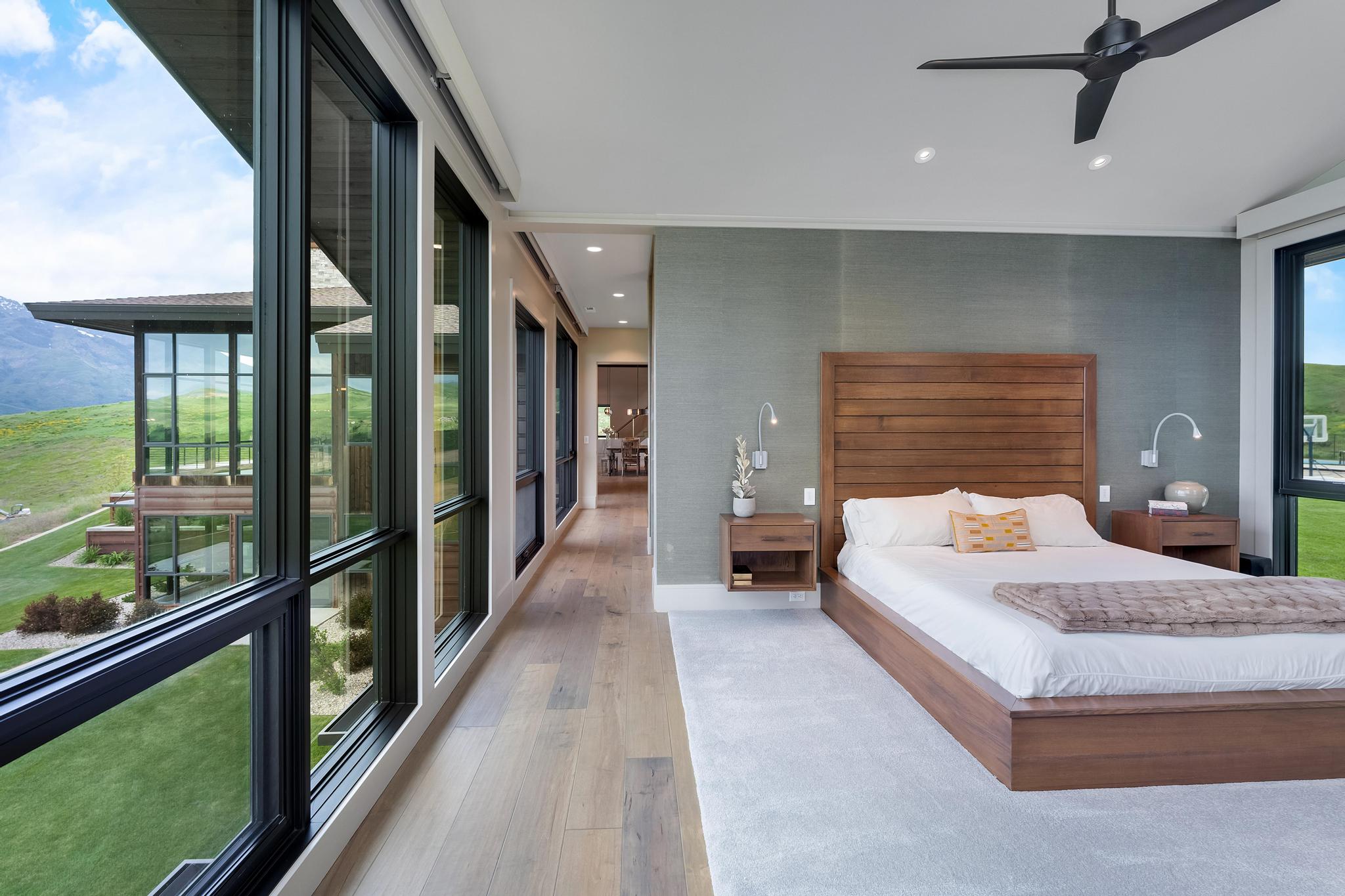 Bedroom featuring floor-to-ceiling windows, wood-finish flooring, recessed lighting, and a modern ceiling fan
