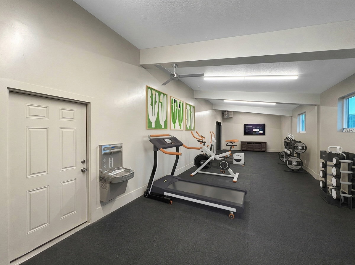 Spacious multi-purpose room featuring durable rubber flooring, a built-in water fountain, recessed lighting, and multiple windows