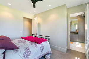 Bedroom featuring recessed lighting, a ceiling fan, plush carpet flooring, a closet with a solid core door, and an entryway to an adjoining bathroom