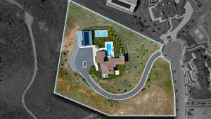 Expansive lot featuring a large residence, a private swimming pool, two sports courts, a winding driveway, and a separate structure with solar panels