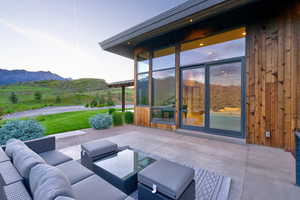 Expansive patio space with a sliding glass door entry to the interior