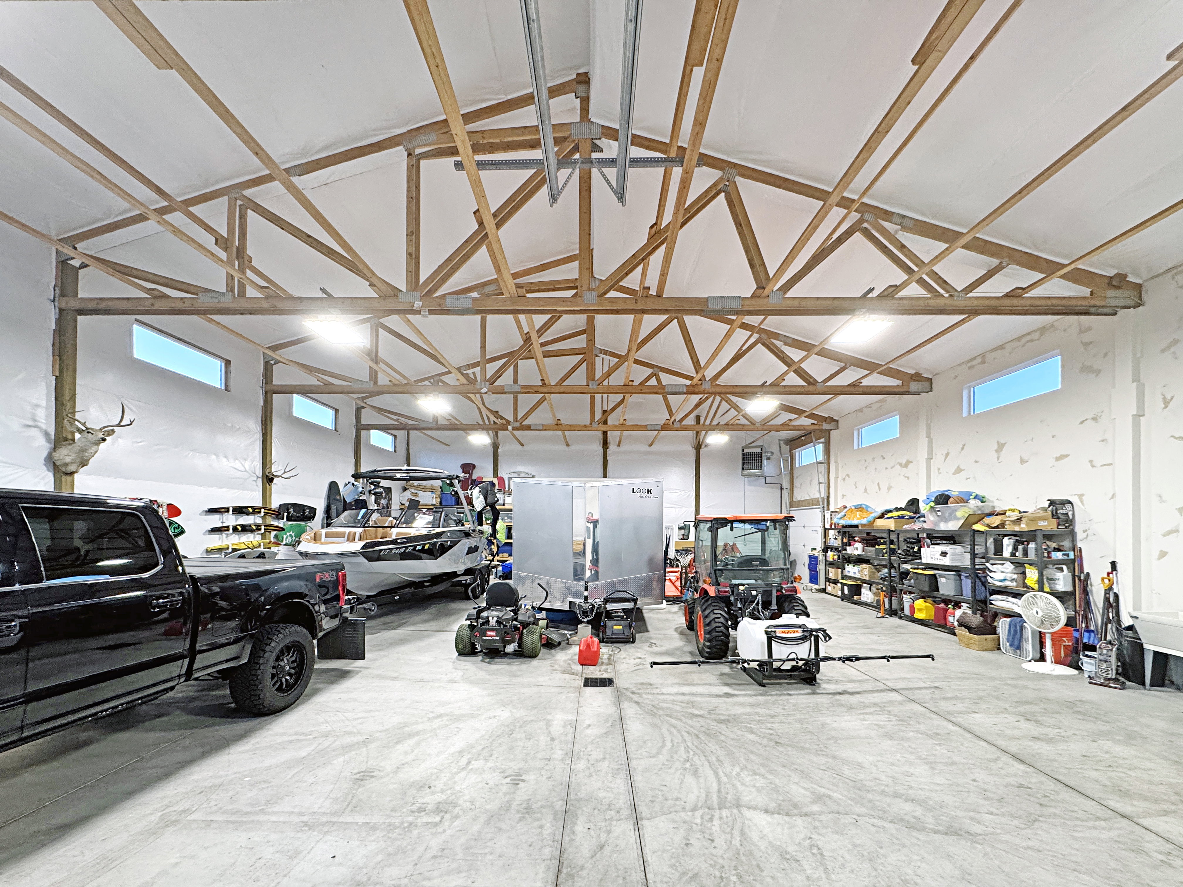 Spacious interior structure featuring exposed timber framing and a high vaulted ceiling