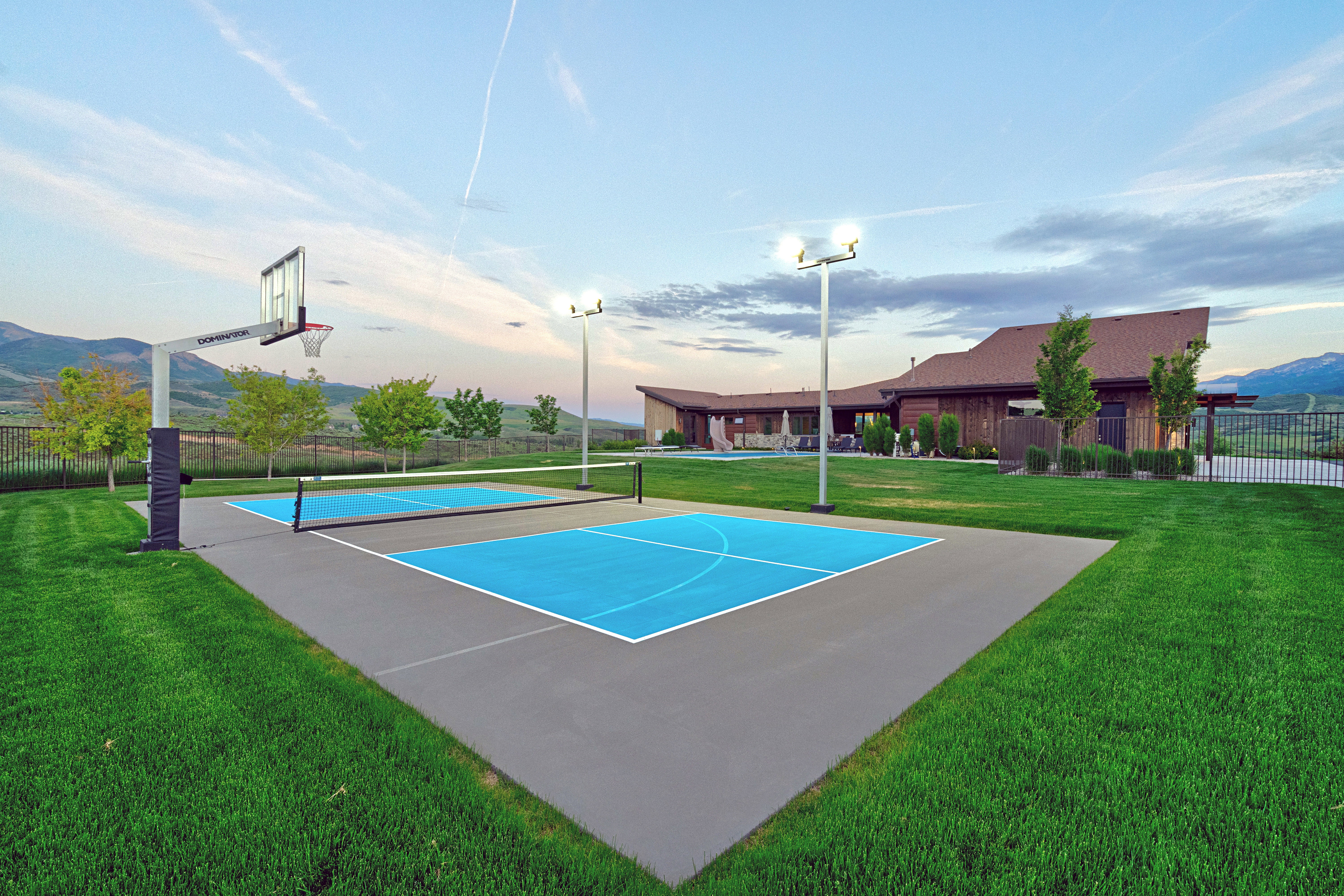 Multi-sport court featuring a basketball hoop and pickleball lines