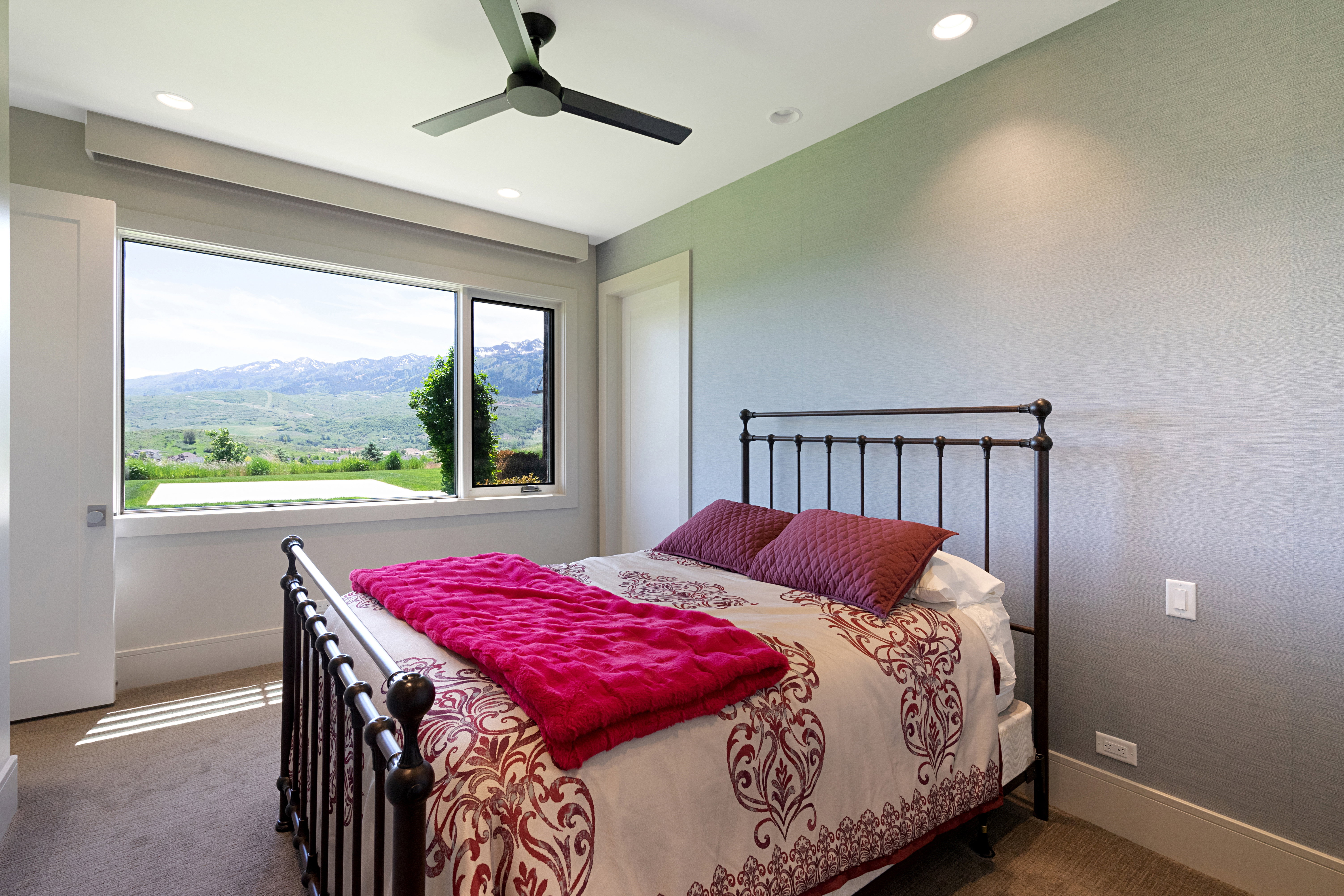Expansive window framing mountain and valley scenery