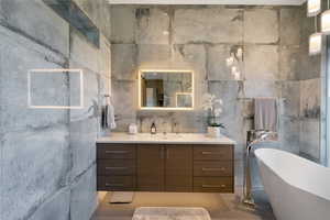 Modern bathroom featuring a floating wood-finish vanity with a white countertop and rectangular sink
