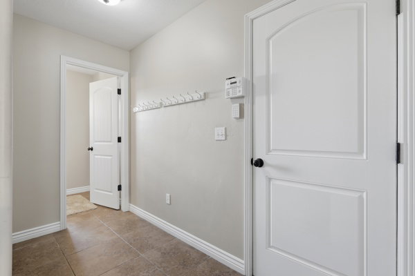 Entryway featuring tiled flooring, white baseboards, and neutral wall paint
