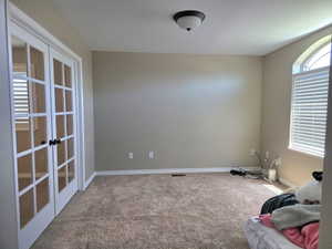 Room featuring plush carpeting, neutral wall paint, and white baseboards