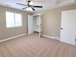 Neutral-toned walls complement the textured carpeting