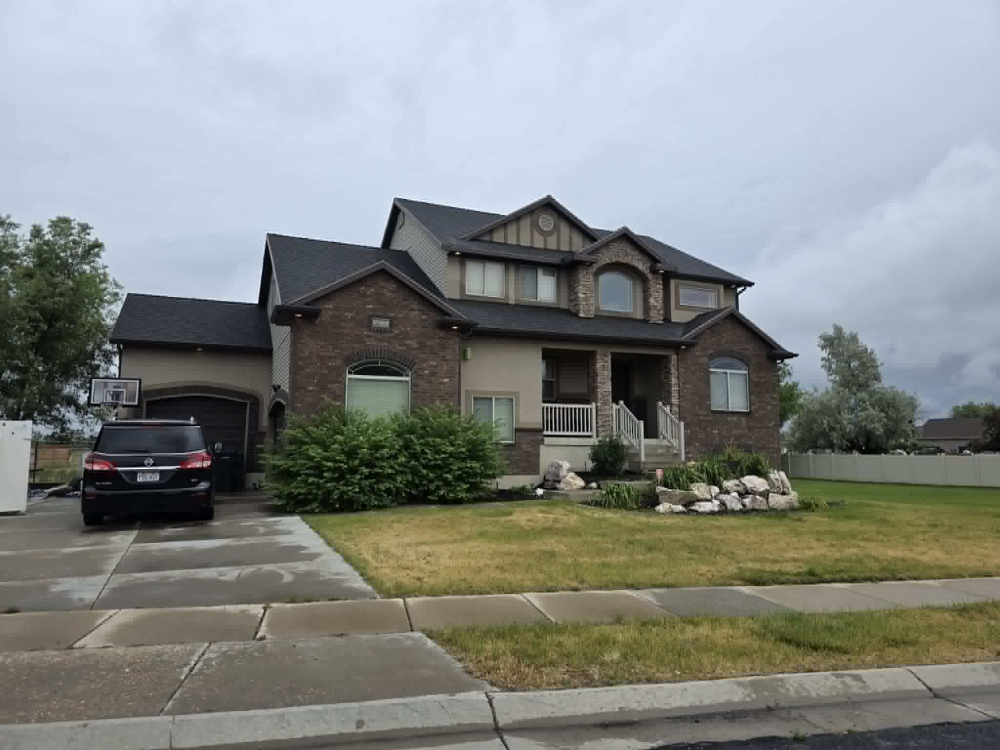 Two-story residence featuring a brick and stucco exterior