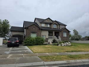 Two-story residence featuring a brick and stucco exterior