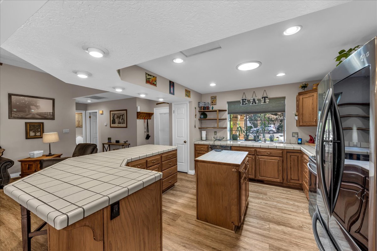 Kitchen featuring wood-finish flooring, recessed lighting, and a window box overlooking exterior landscaping