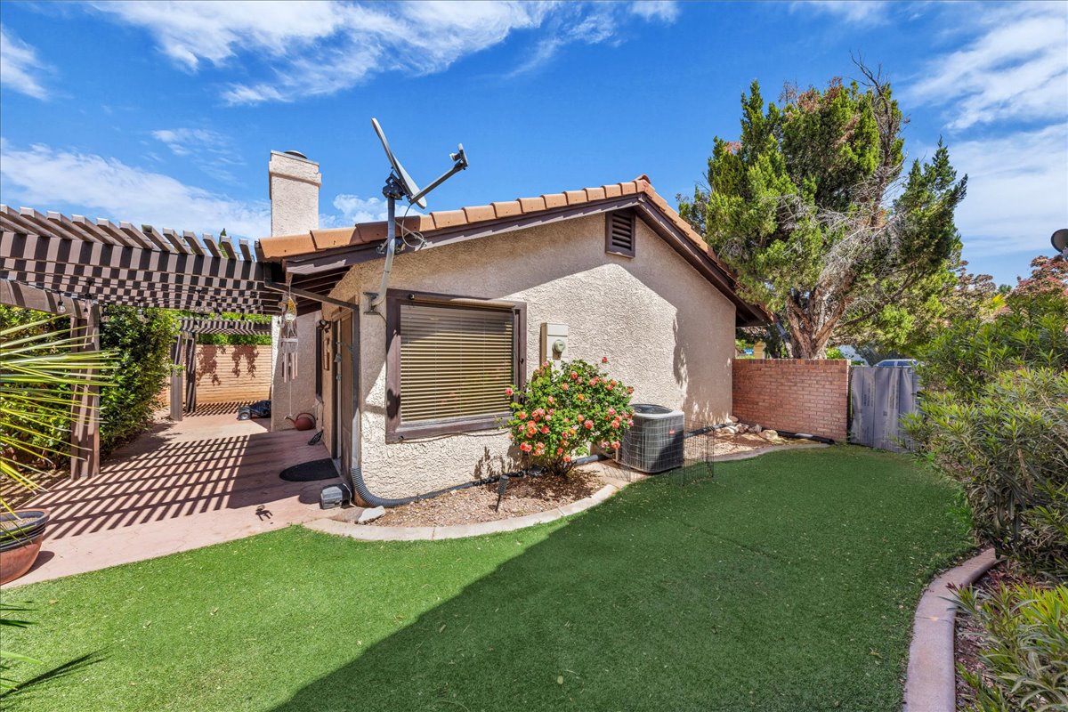 Private Rear Yard with turf, patio, and dual pergolas