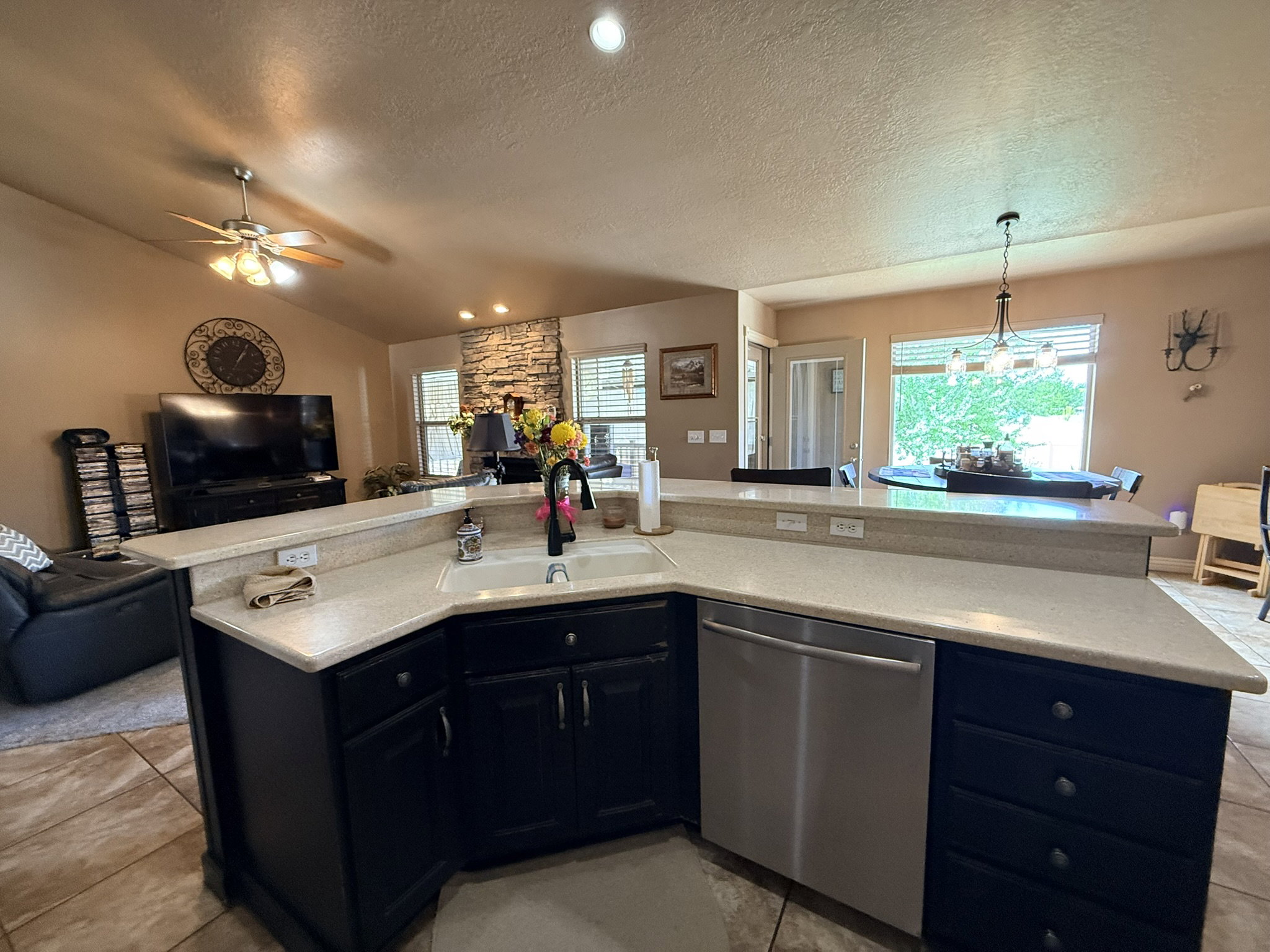 Expansive kitchen island featuring light-toned countertops and dark cabinetry