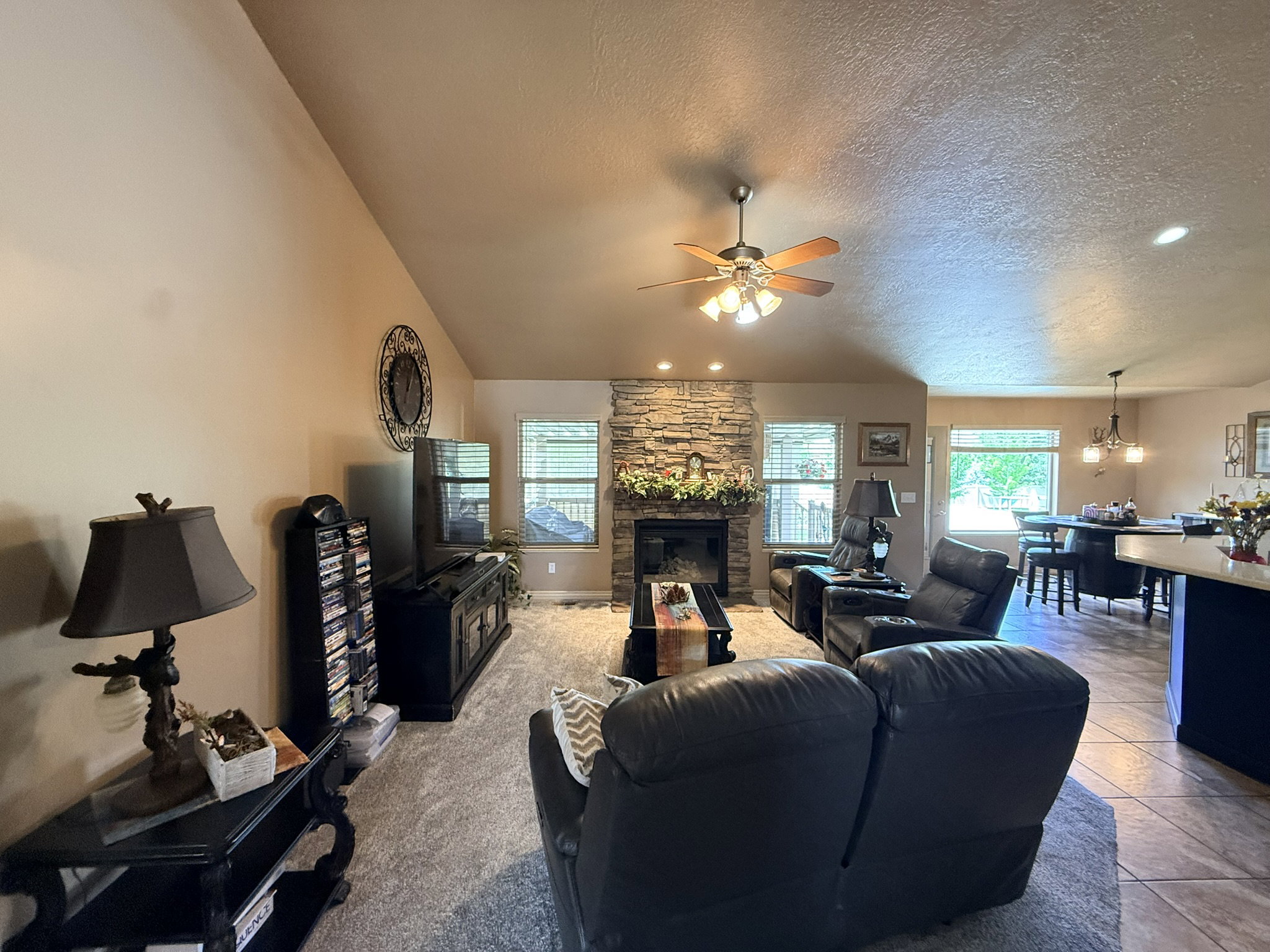 Living area featuring a stone-clad fireplace and hearth