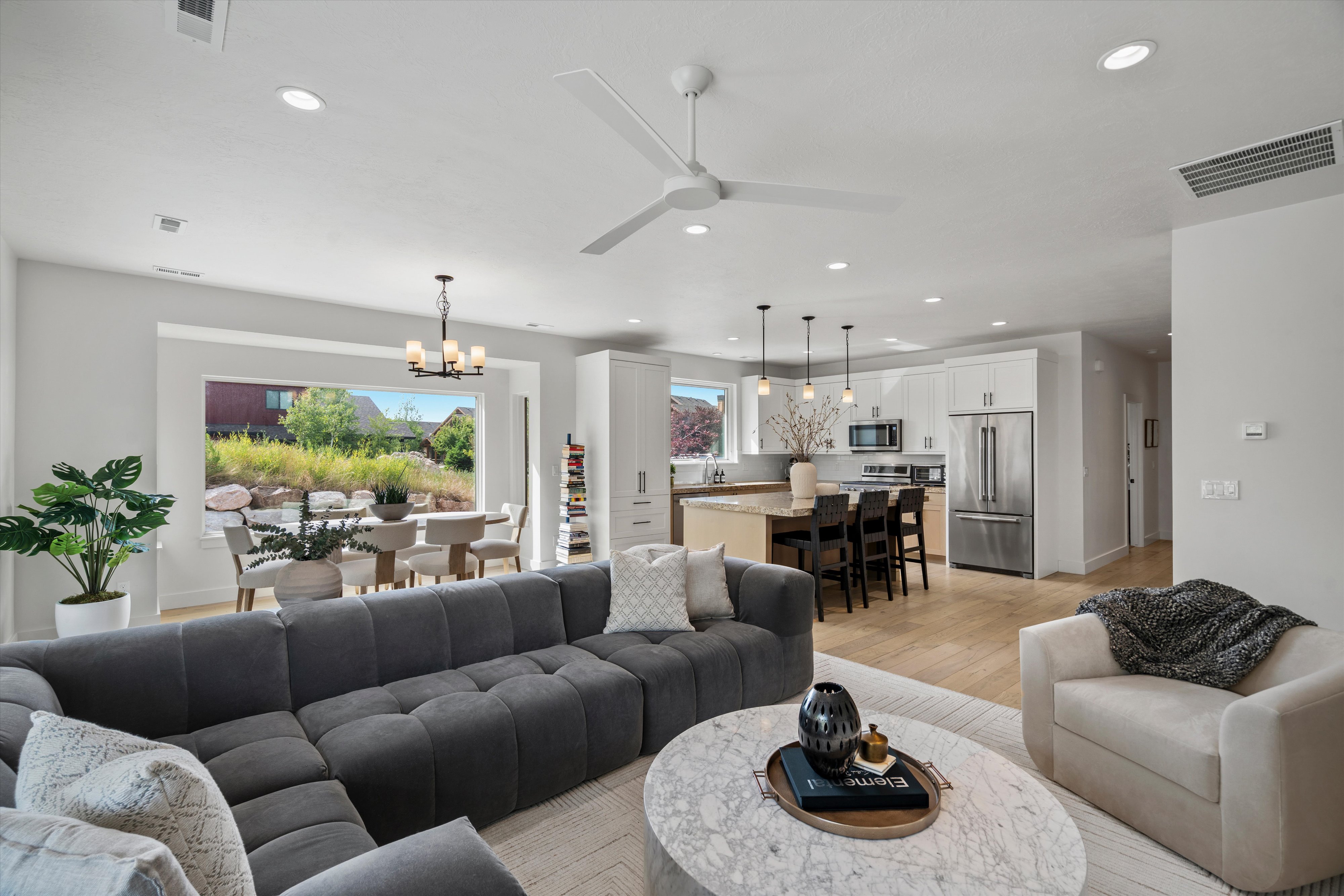 Open-concept living area featuring light wood-finish flooring and recessed lighting.