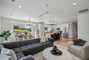 Open-concept living area featuring light wood-finish flooring and recessed lighting.