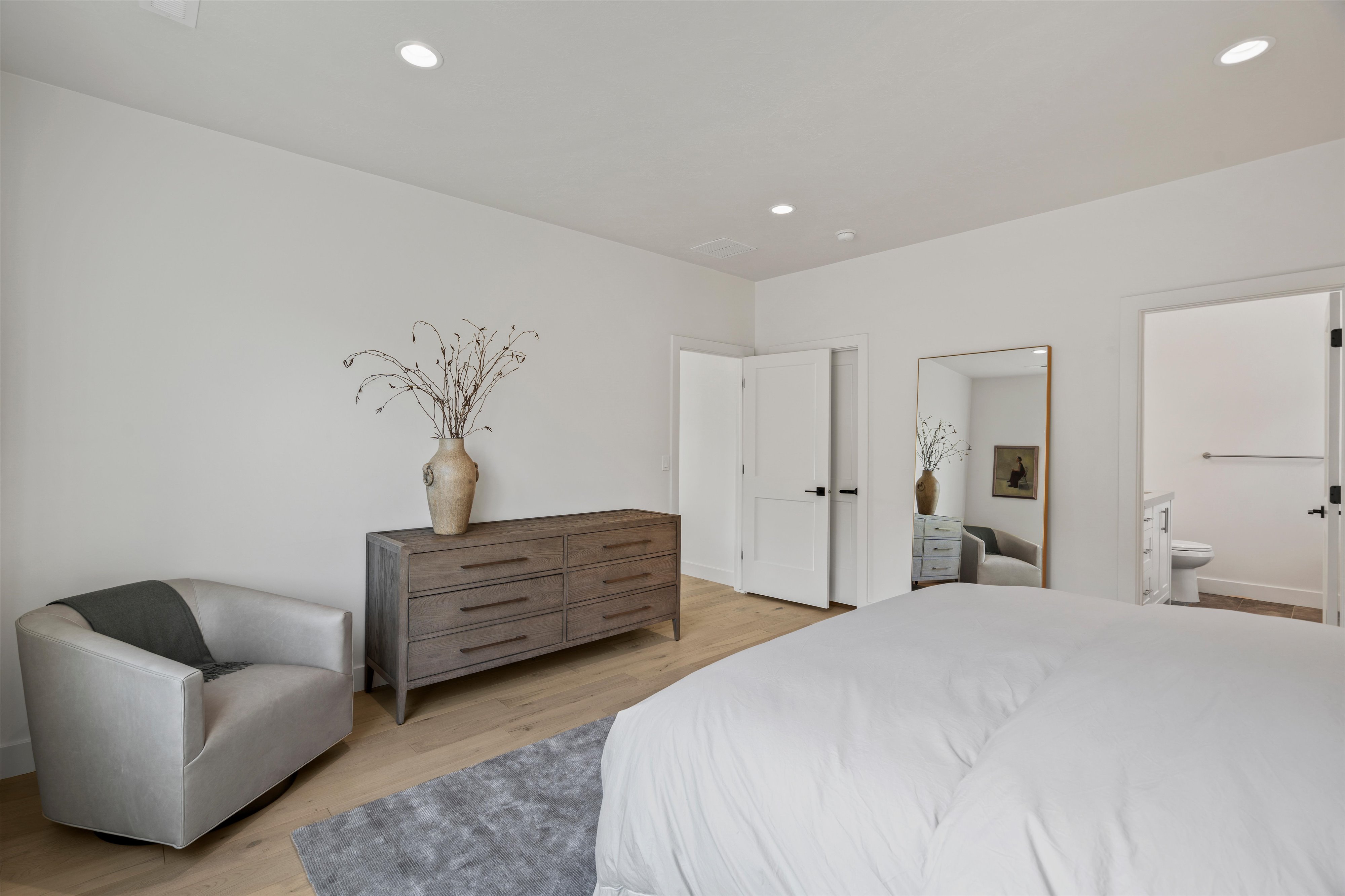 Oversized primary suite with large picture window, en-suite bath, and large walk-in closet.