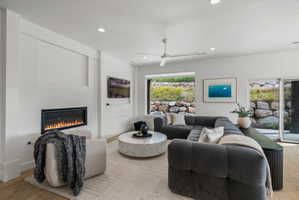 Bright interior featuring fireplace and large picture window.